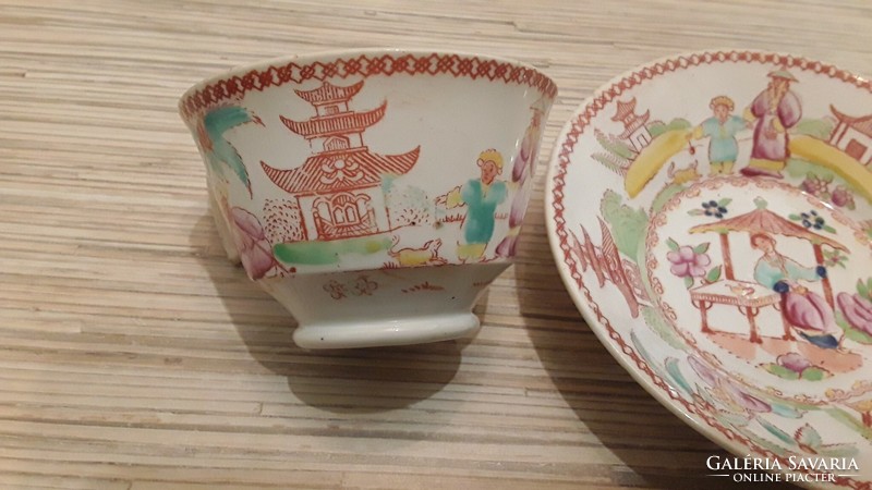 Antique oriental pattern faience tea cup with small plate.