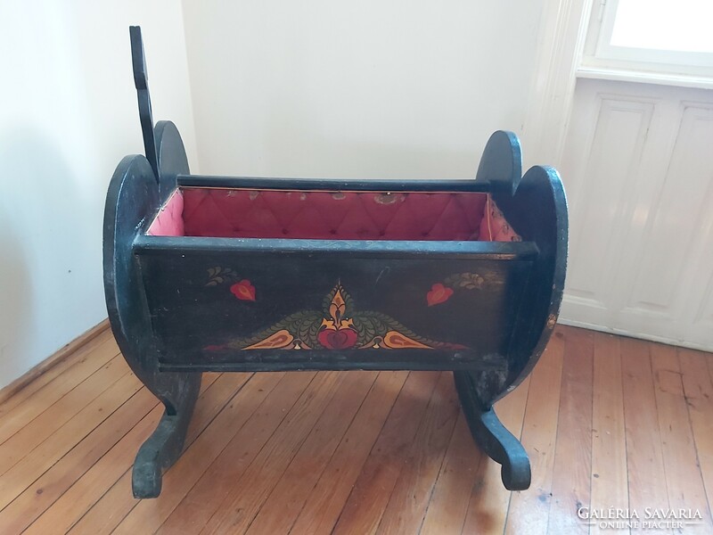 Old, richly painted wooden cradle