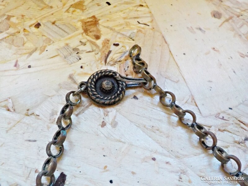 Old metal necklace decorated with blue stones