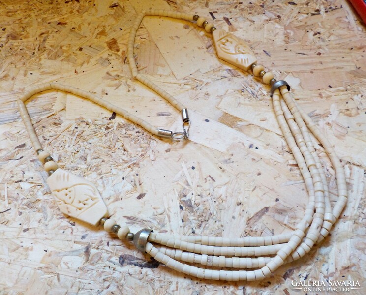 Carved necklace made of long bone