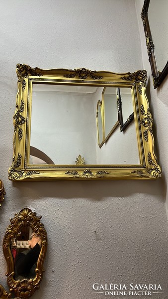 Wall mirror in a decorative blonde frame