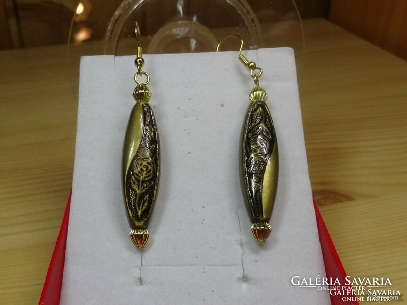 Gold-colored special hanging earrings, made of acrylic with metal decoration.