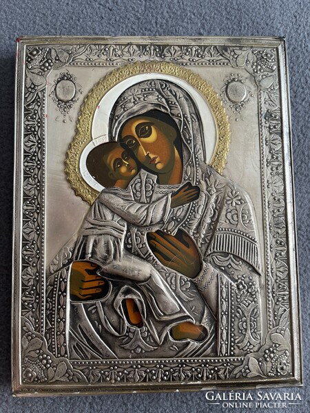 A wonderful hand-painted icon with a metal plaque with a raised gloria.
