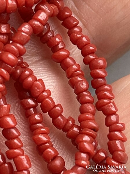 Real coral, three rows of pearls, with a silver clasp, very beautiful.