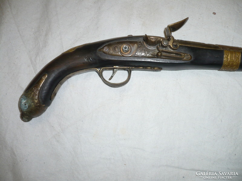 Ornate brass front-loading flintlock replica pistol