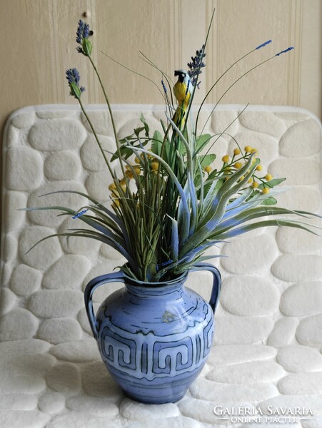 Glazed ceramic vase with a blue geometric pattern with two ears with a lovely artificial flower with a bird