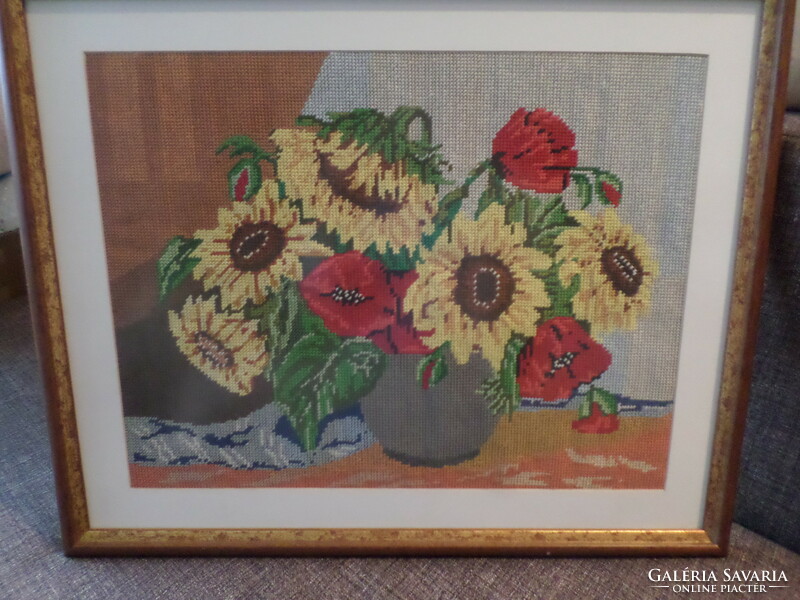 Very beautiful tapestry picture with sunflowers and poppies behind a glass panel.