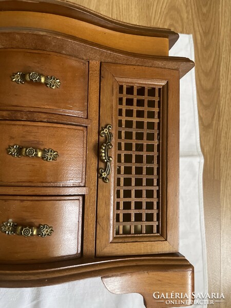 Large hardwood jewelry cabinet.