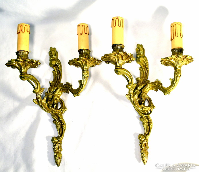 A pair of solid copper double-armed wall levers in Rococo style
