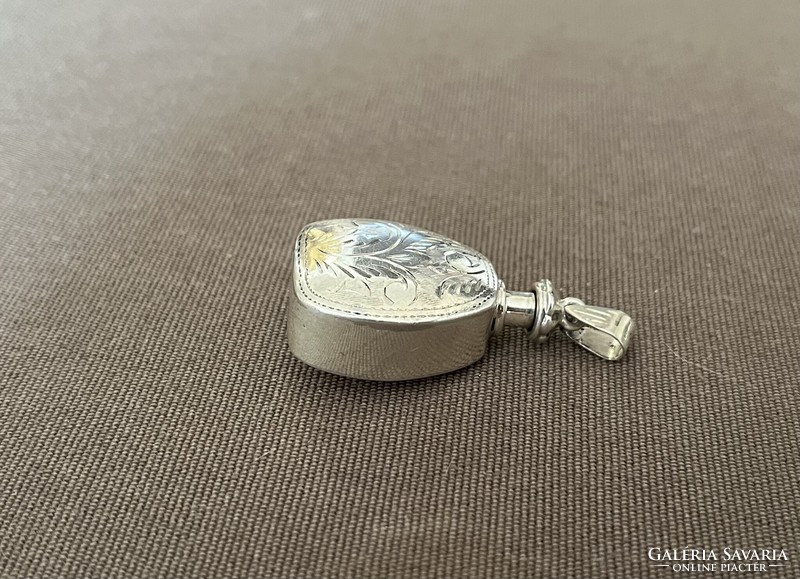 Silver pendant holding cologne