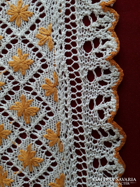 Knitted lace tablecloth with embroidered decoration