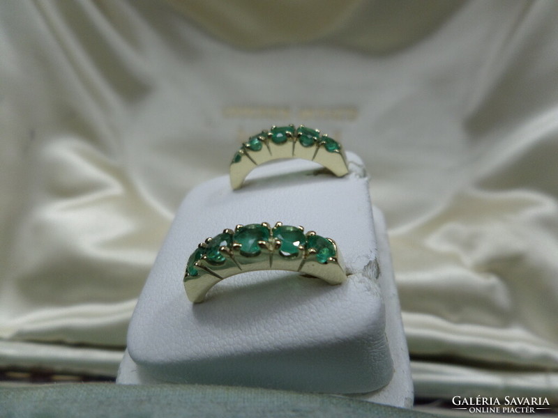 Gold stud earrings with a pair of emeralds