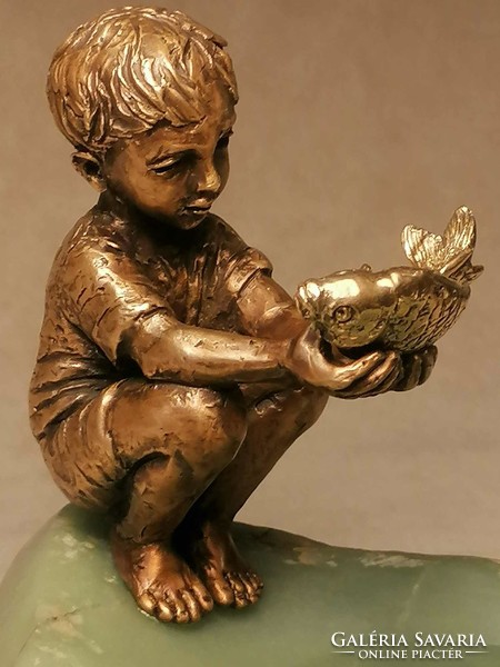 The goldfish and the boy bronze statue