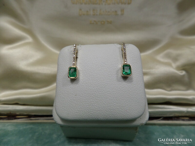 Gold stud earrings with a pair of emeralds and snow-white tiny glasses