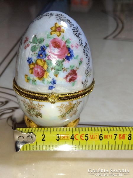Beautiful flower-patterned mother-of-pearl porcelain jewelry box in the shape of an egg