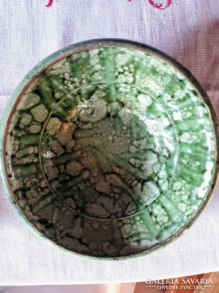 Green-glazed, fired clay, folk wall plate that can be hung