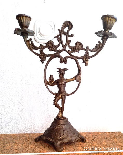 Old two-pronged copper candlestick with court jester