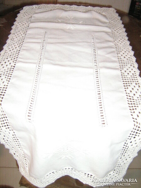 Beautiful azure embroidered crochet runner with lacy edge on white tablecloth