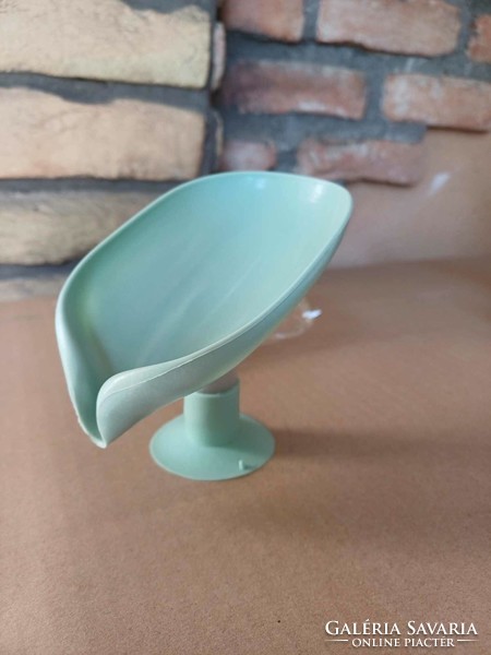 Soap holder in the shape of a plastic leaf with a base