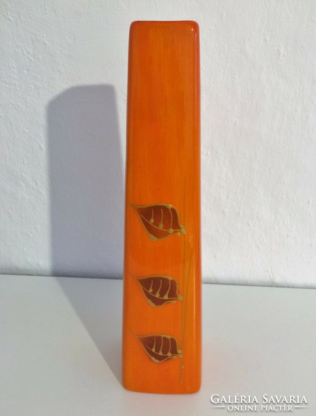 Orange glazed ceramic vase with leaf pattern