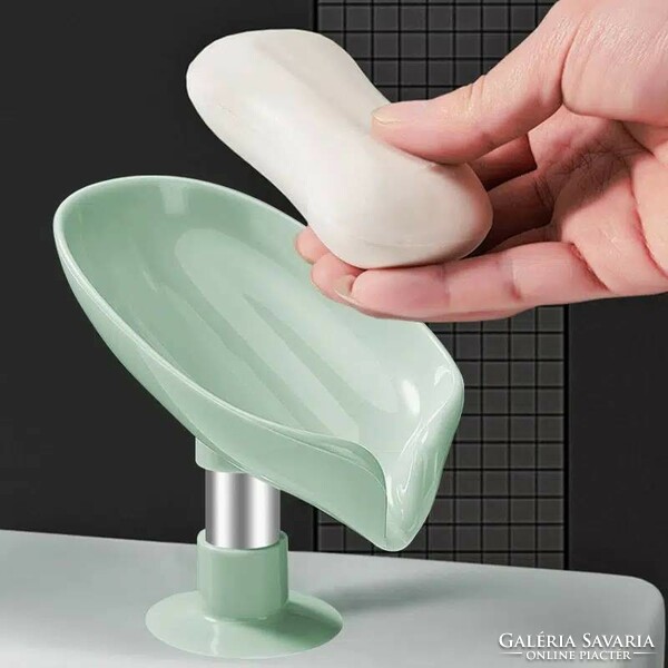 Soap holder in the shape of a plastic leaf with a base