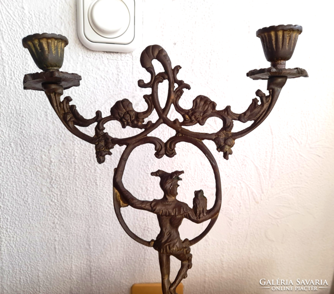 Old two-pronged copper candlestick with court jester