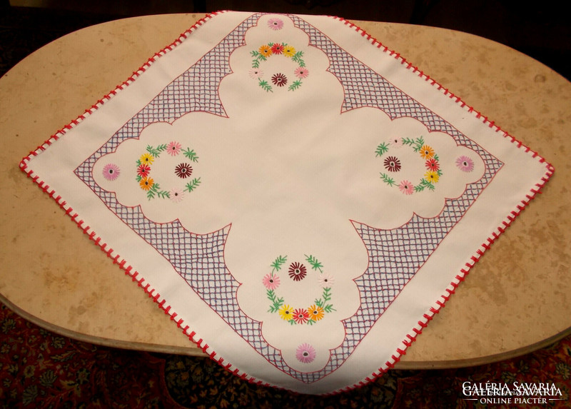 Hand-embroidered daisy tablecloth.