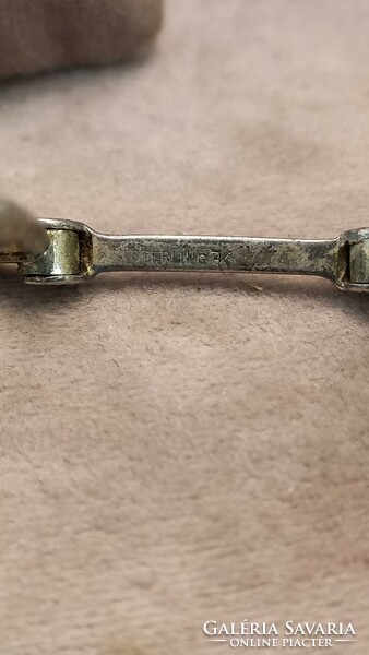 Antique silver lornyon on a silver necklace