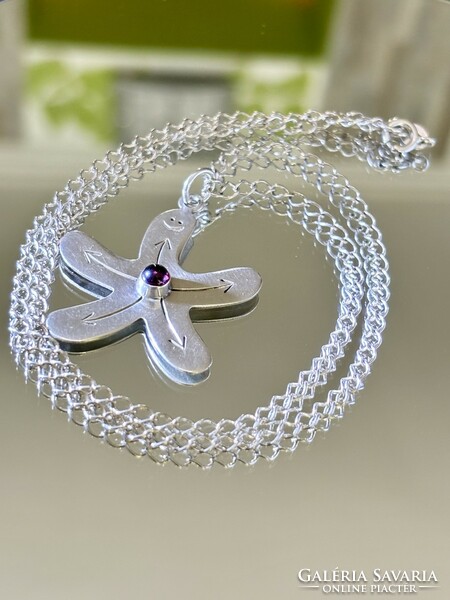 A wonderful, cheerful silver necklace with a garnet stone