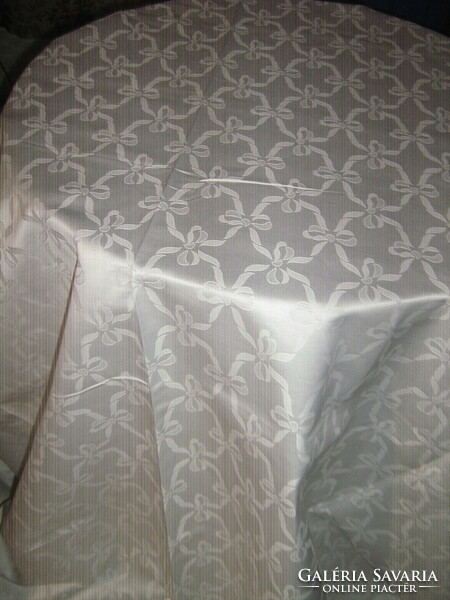 A huge snow-white damask tablecloth with a beautiful ribbon pattern, new