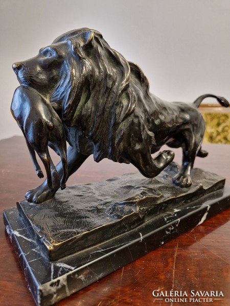 Bronze lion on a marble base