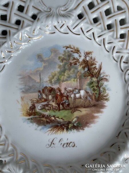 Antique large porcelain decorative plate with openwork edges with a scenic picture.
