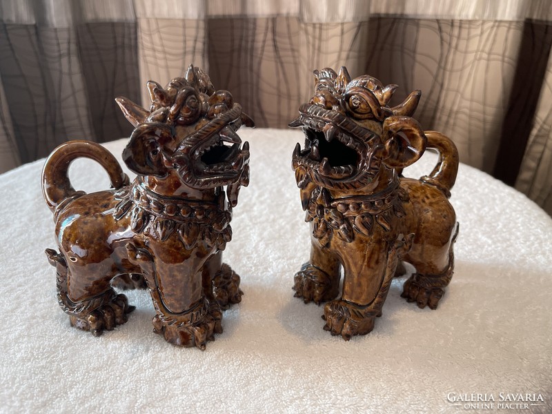 A pair of Chinese hard ceramic foo dogs is a unique valuable rare piece.