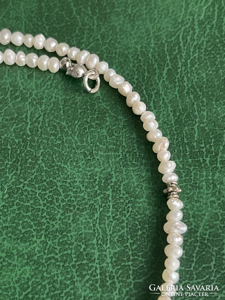 String of real pearls with silver fittings, elegant jewelry.