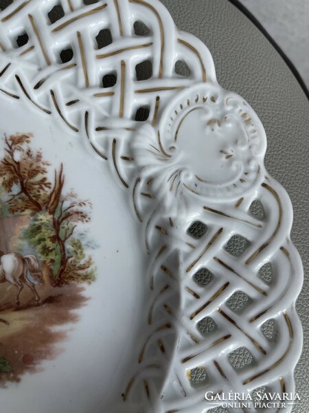 Antique large porcelain decorative plate with openwork edges with a scenic picture.