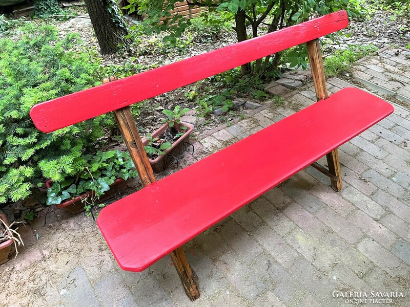 Old renovated red garden bench