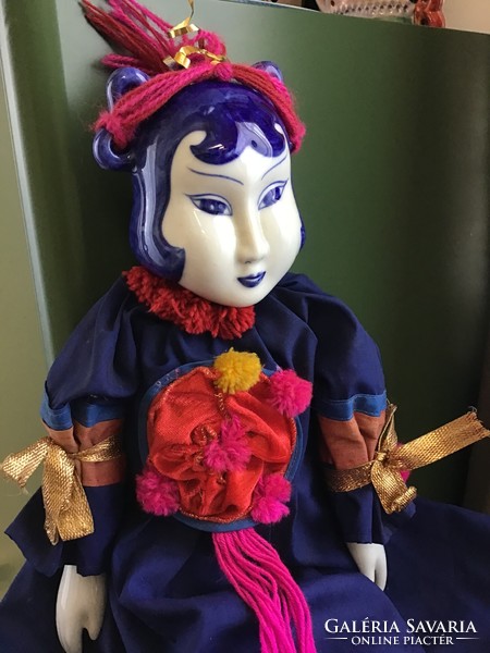 Large porcelain head doll with porcelain hand and foot ends in handmade clothing