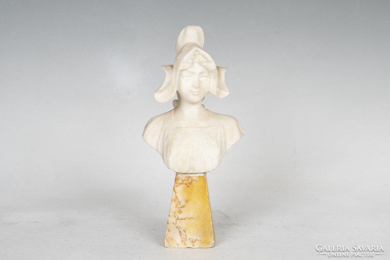 Alabaster bust of a woman on a marble plinth