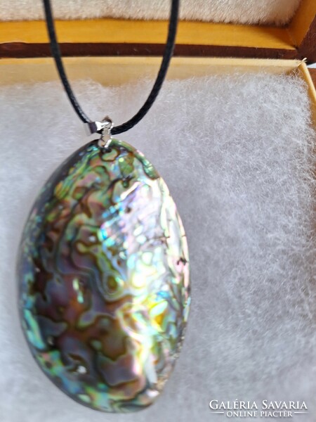 Giant abalone shell pendant on leather thread.