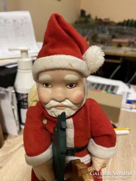 An old Santa with a porcelain head and a wooden rocking horse
