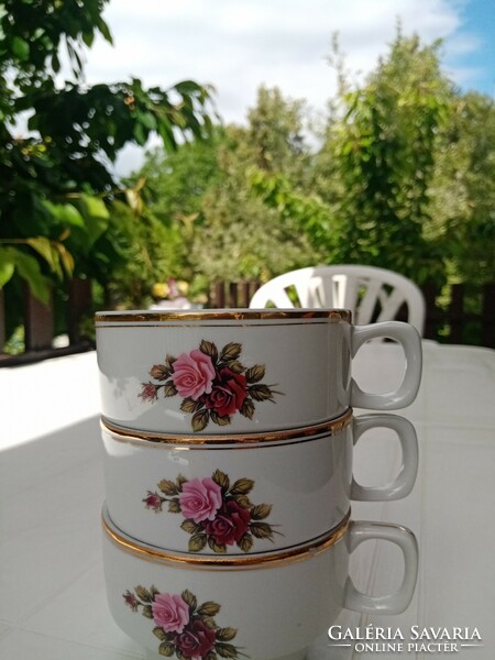 From a marked Hólloháza floral porcelain tea set: 3 cups, 1 saucer, 1 sugar bowl with lid