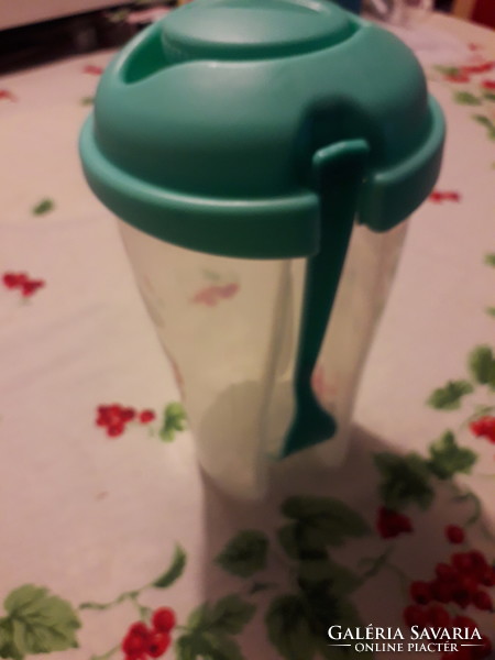 Turquoise plastic water bottle with a fork with a closable top drinking glass 20x10 cm.