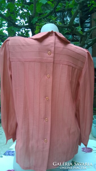 A really feminine coral-colored blouse with a bow, buttons all the way at the back - even for an occasion!
