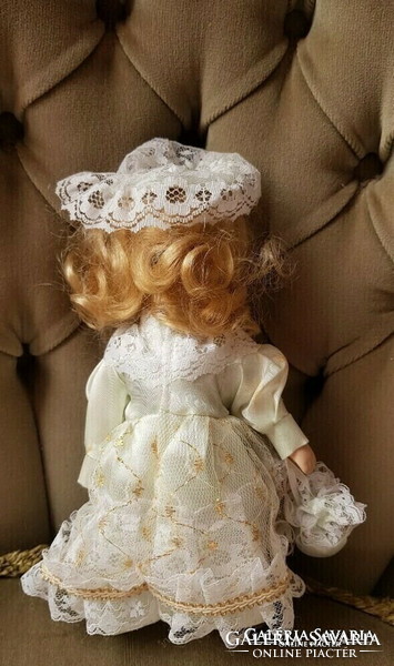 A charming blonde doll with a porcelain head