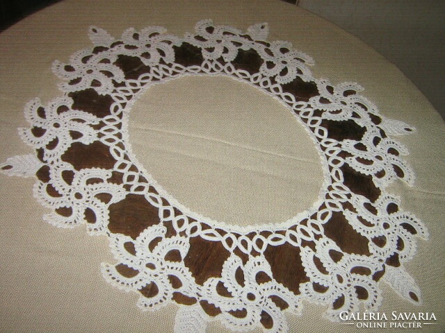 Beautiful cream-colored tablecloth with hand-crocheted flower inserts