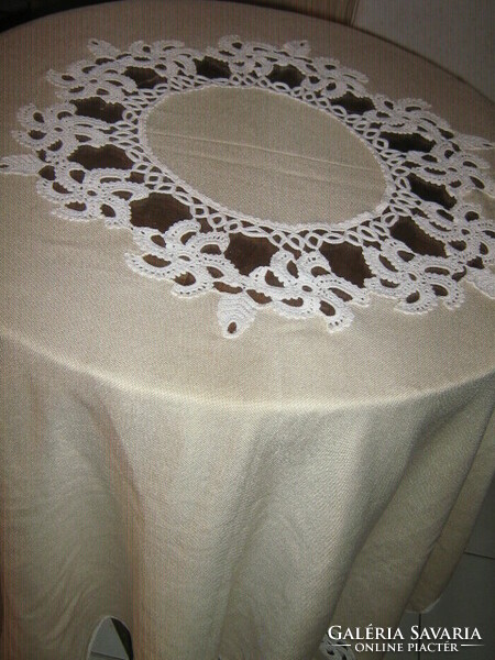 Beautiful cream-colored tablecloth with hand-crocheted flower inserts