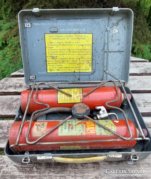 Old, retro Russian portable camping gas stove in original metal box, with travel tags