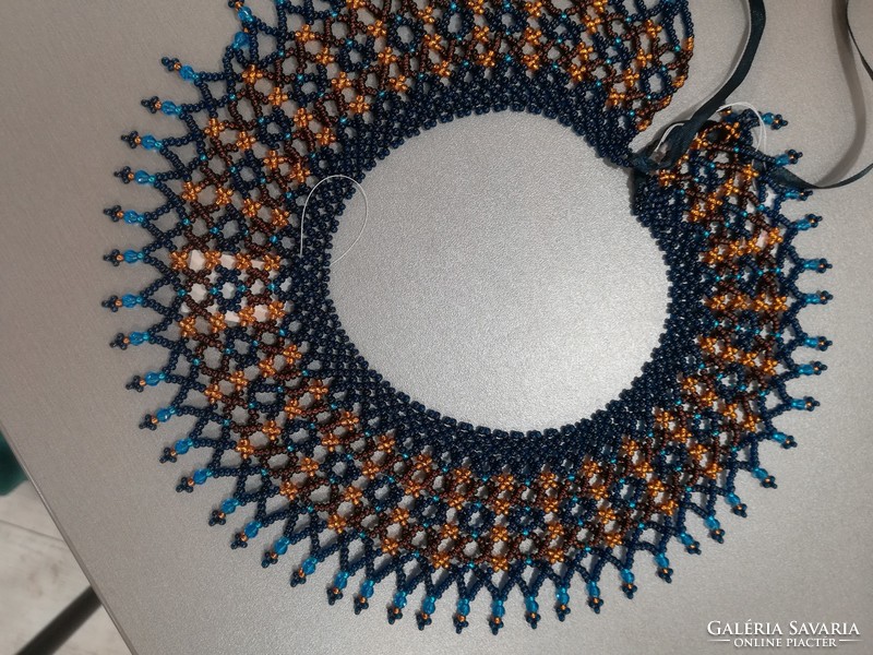 Montana blue cross-stitched pearl collar