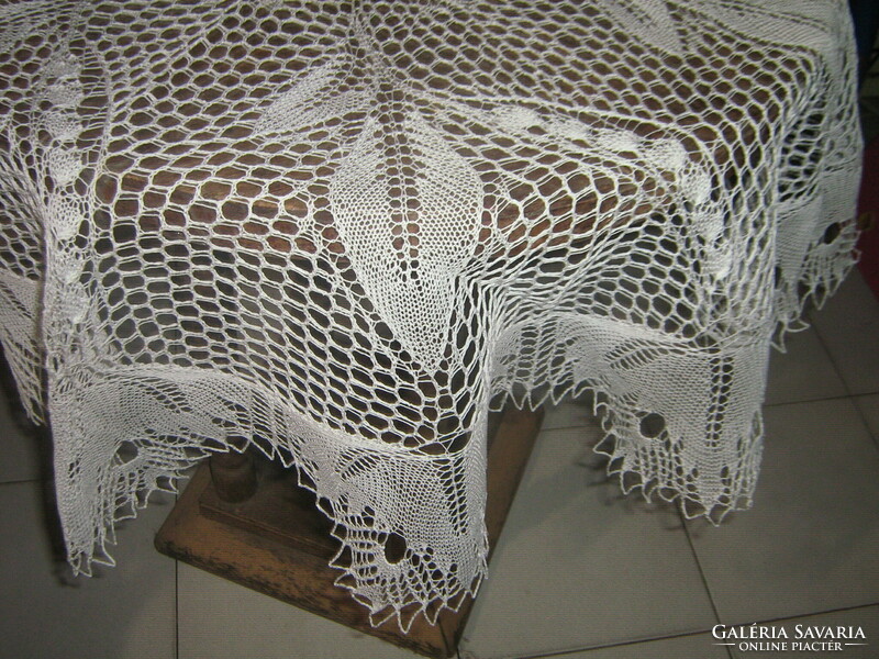 Beautiful white filigree round crochet tablecloth