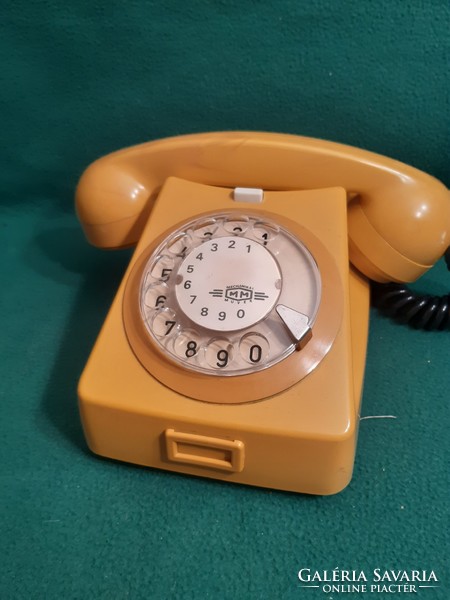 Retro yellow dial phone.